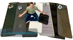 website editor Greg sitting on assorted PEMF mats reviewed on this page